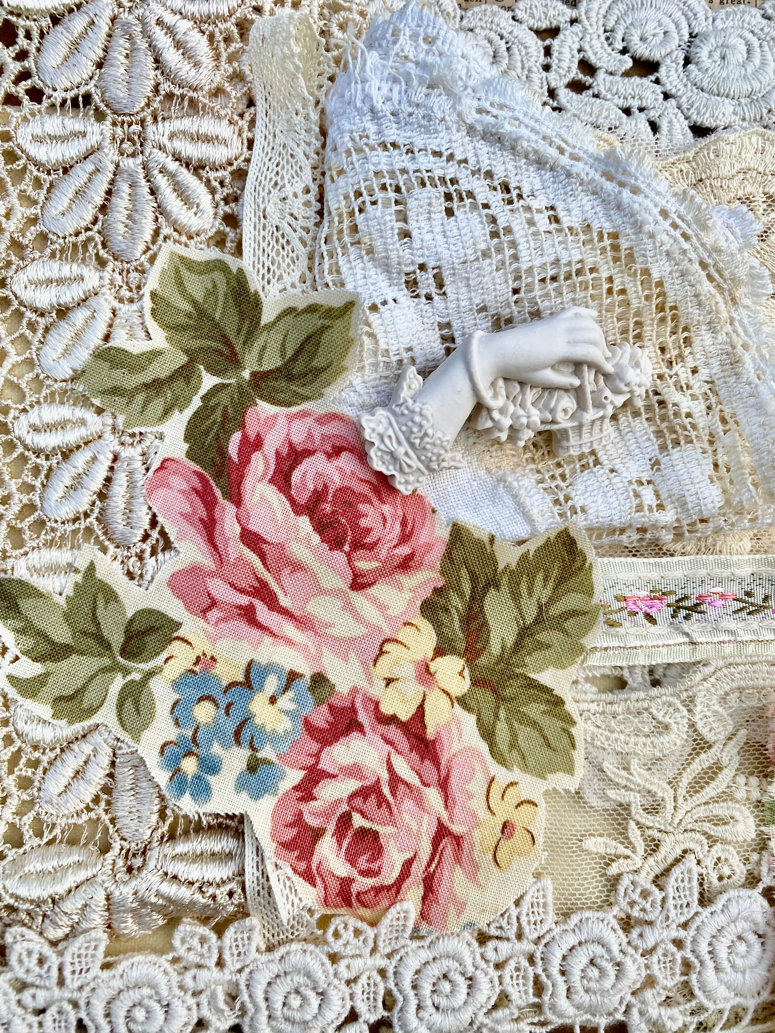 Resin Edwardian hand brooch holding a basket of flowers.